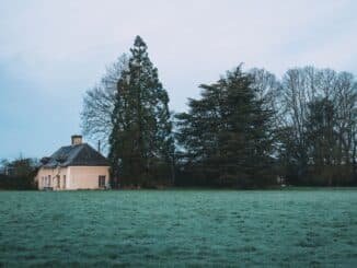Serene countryside scene with house and trees in Rennes, France.