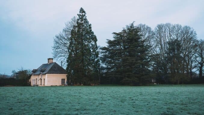 Serene countryside scene with house and trees in Rennes, France.