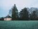 Serene countryside scene with house and trees in Rennes, France.
