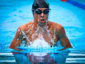 Dynamic shot of a swimmer in a swimming pool in Saint-Pierre, La Réunion, showcasing athletic focus and determination.