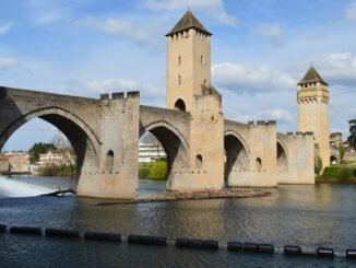 Explore Pont Valentré, a stunning medieval bridge in Cahors, with its iconic towers and river view.