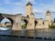 Explore Pont Valentré, a stunning medieval bridge in Cahors, with its iconic towers and river view.