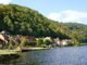 Charming riverside village of Beaulieu-sur-Dordogne, showcasing traditional French architecture along the Dordogne River in summer.