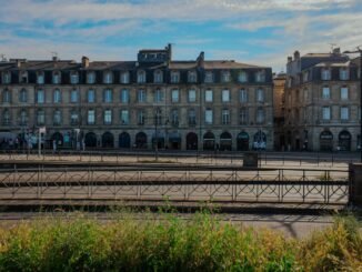 Elegant historic buildings in Bordeaux, France under a clear blue sky.