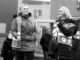 Black and white image of women in reflective vests participating in an outdoor protest.