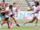 Rugby players in action showcasing teamwork and athleticism during a match.